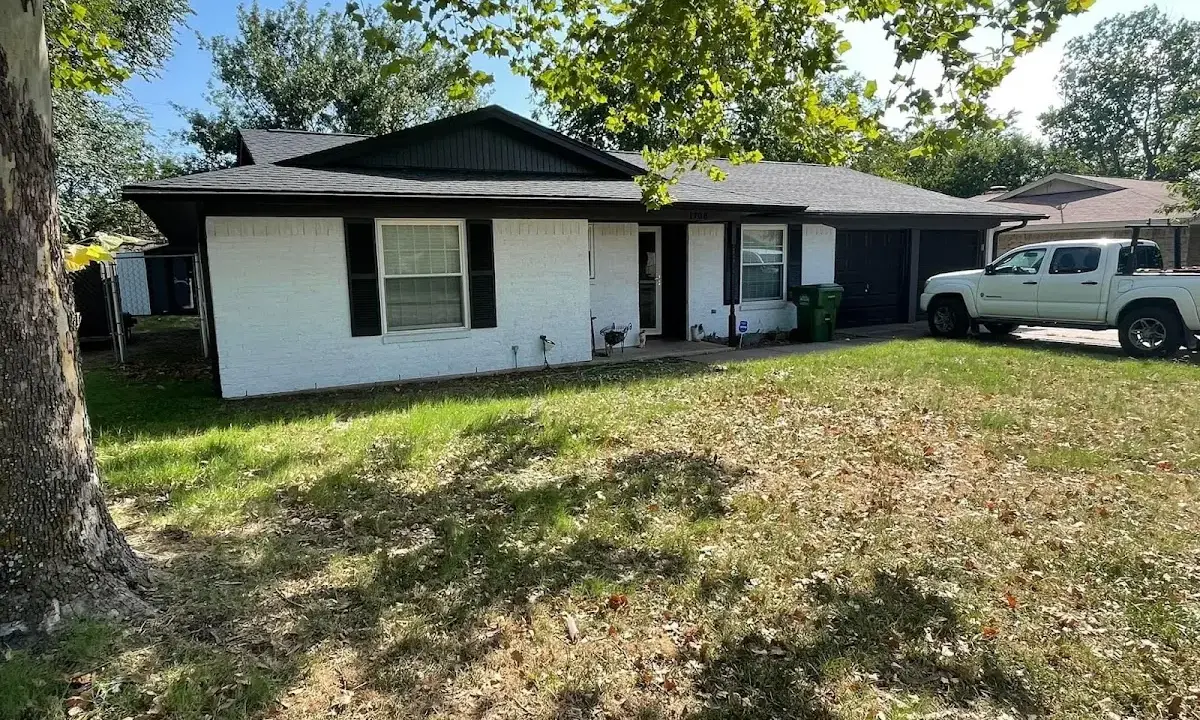 Professional roofing crew working on a residential roof in Long Branch